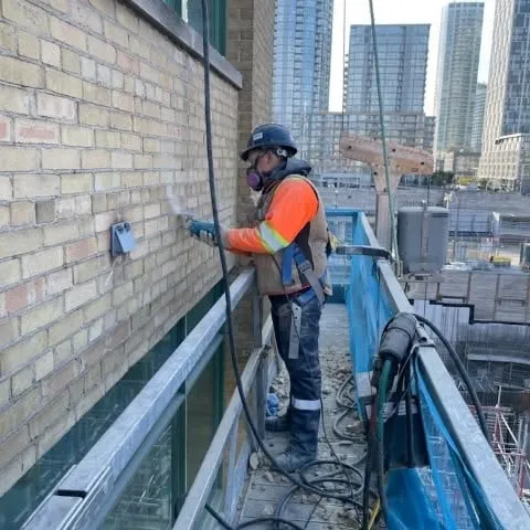 Devon Lorenzen, founder of Stone by the Sea, working on-site